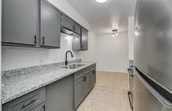 a kitchen with a sink and cabinets