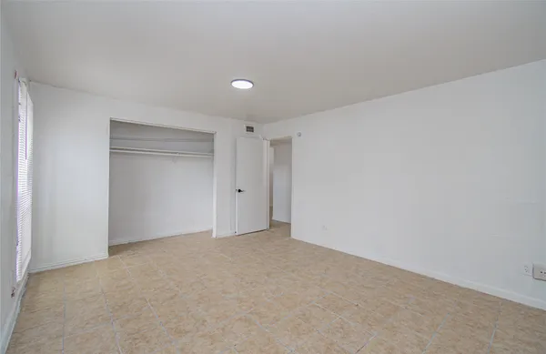 a view of an empty room and closet area