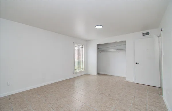 a view of an empty room and a window