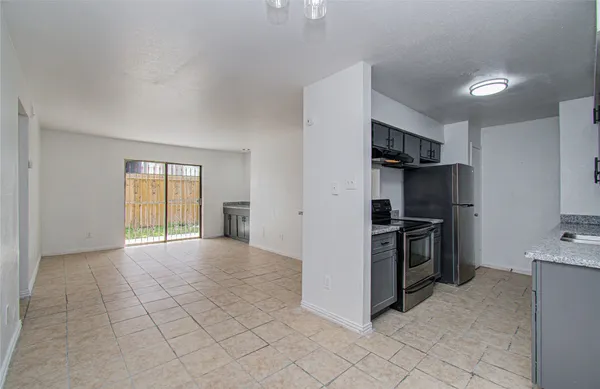 a view of a kitchen with refrigerator stove and a sink