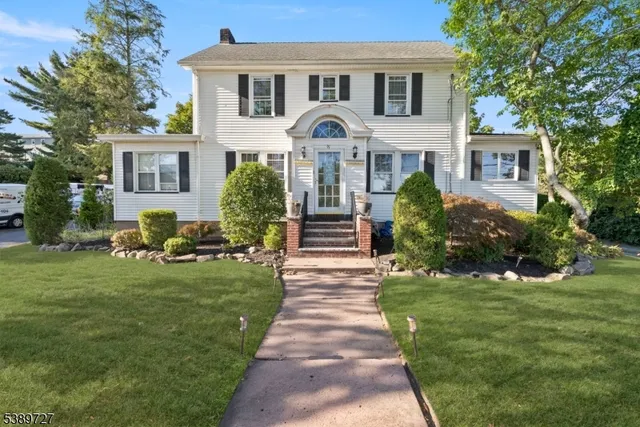 a front view of a house with garden and porch