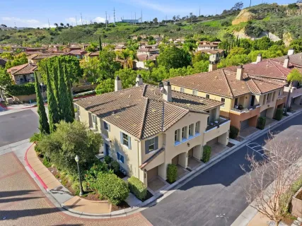 an aerial view of multiple houses with a yard