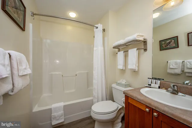 an aerial view of a house with a yard and lake view