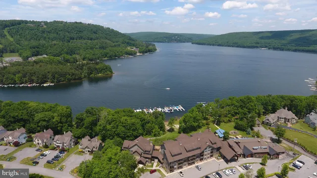 an aerial view of a house with a garden and lake view