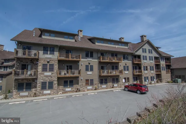 a front view of a house with parking area