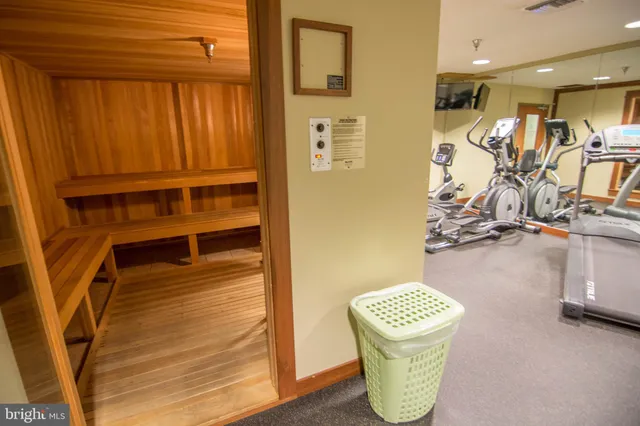 a room with gym equipment and a table