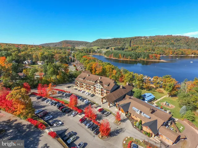 an aerial view of residential houses with outdoor space and river