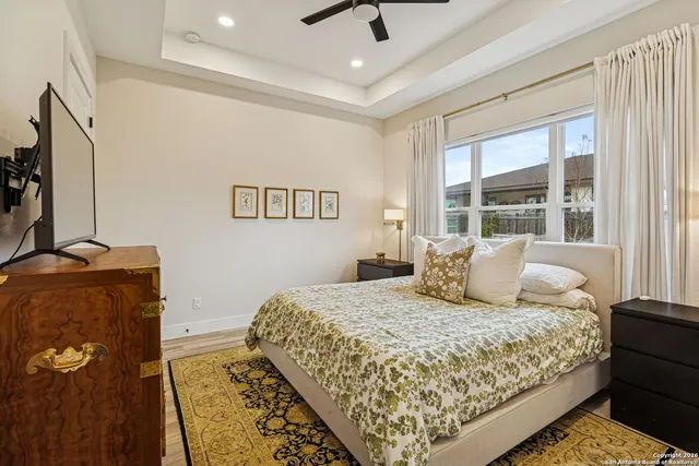 a bedroom with a large bed and a window