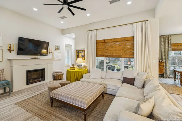 a living room with furniture a fireplace and a flat screen tv