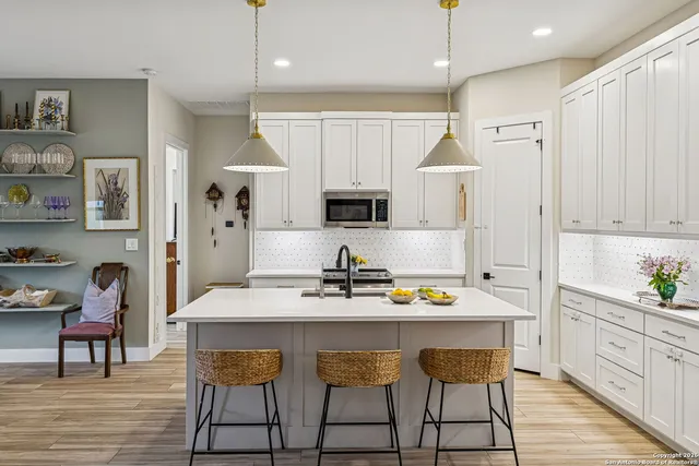 a kitchen with a sink cabinets and window