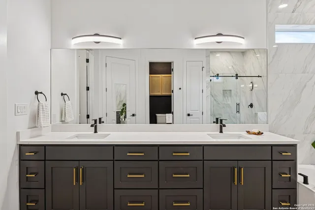 a bathroom with a double vanity sink mirror and