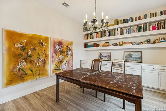 a view of a dining room with furniture and chandelier