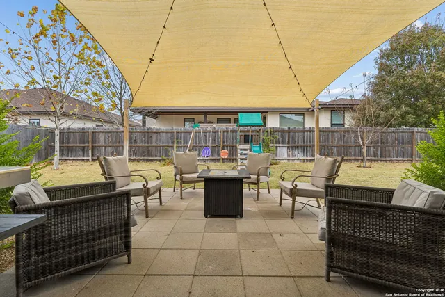a view of a patio with couches and table and chairs