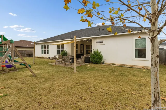 a view of a house with a backyard