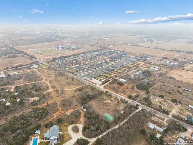an aerial view of residential houses with outdoor space