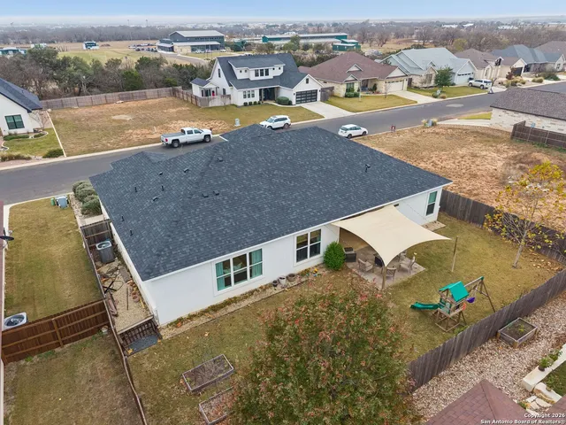 an aerial view of residential houses with outdoor space