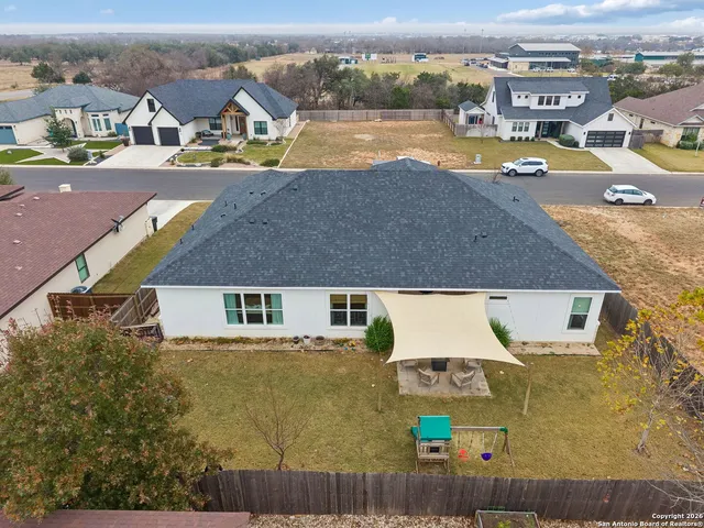 an aerial view of residential houses with outdoor space