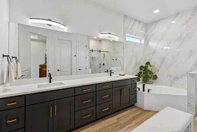 a bathroom with a double vanity sink mirror and toilet