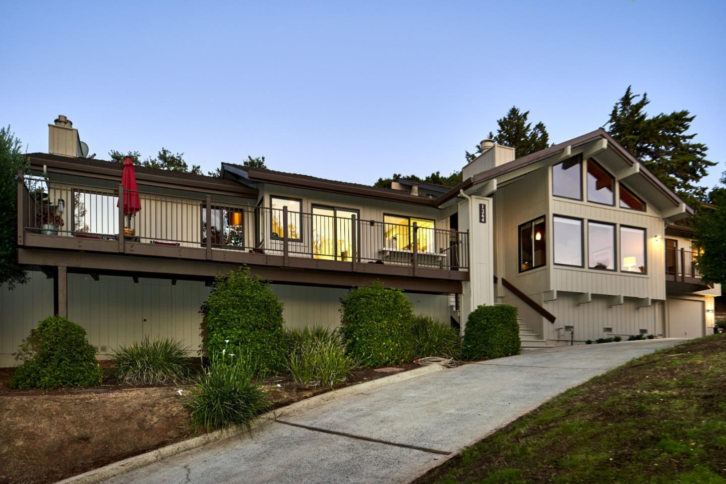 a front view of a house with a garden and plants