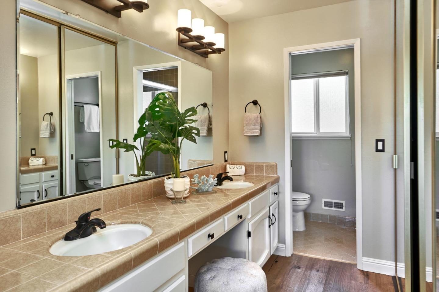1264 Chateau Drive San Jose, CA 95120 - Photo 28 of 44 a bathroom with a granite countertop sink a toilet and mirror
