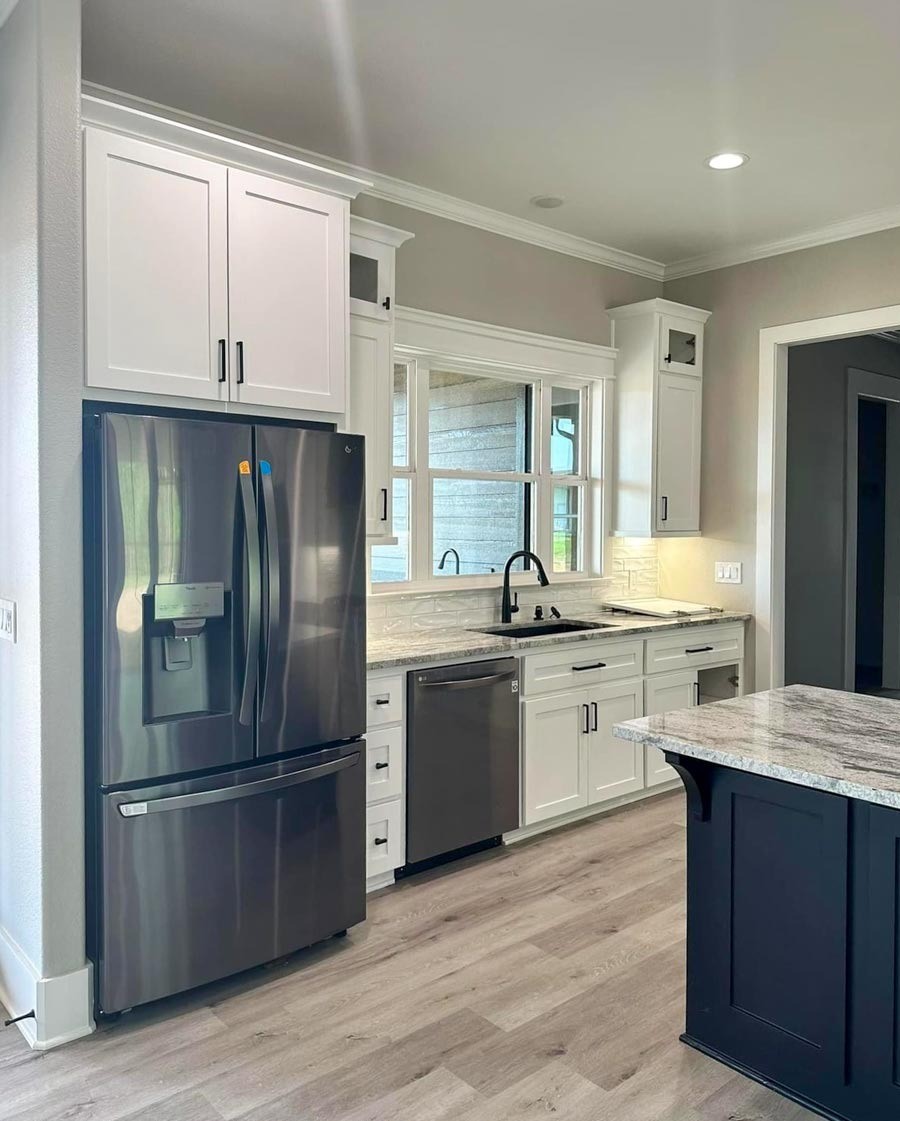 4967 Ward Bend Road Sealy, TX 77474 - Photo 3 of 6 a kitchen with a refrigerator sink and cabinets