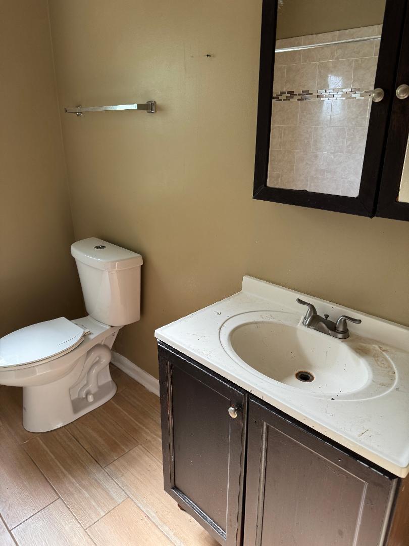10200 South Rhodes Avenue Chicago, IL 60628 - Photo 12 of 22 a bathroom with a sink and a toilet