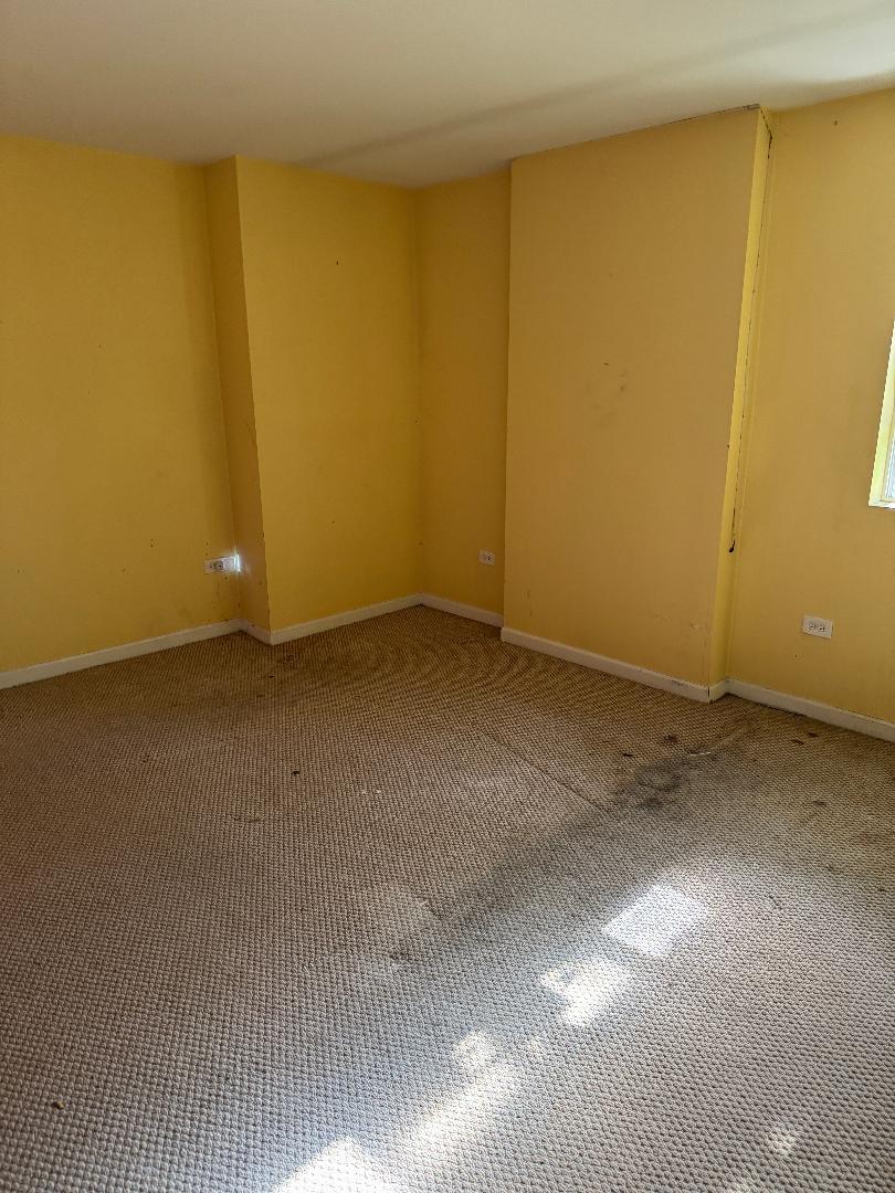 10200 South Rhodes Avenue Chicago, IL 60628 - Photo 9 of 22 a view of an empty room with a window