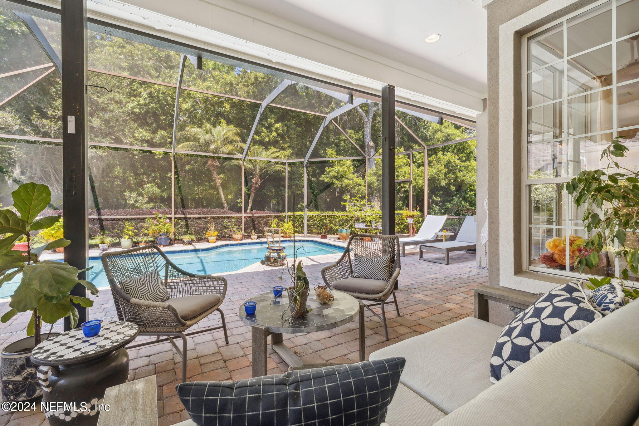 a view of a living room and dining room with furniture and floor to ceiling windows