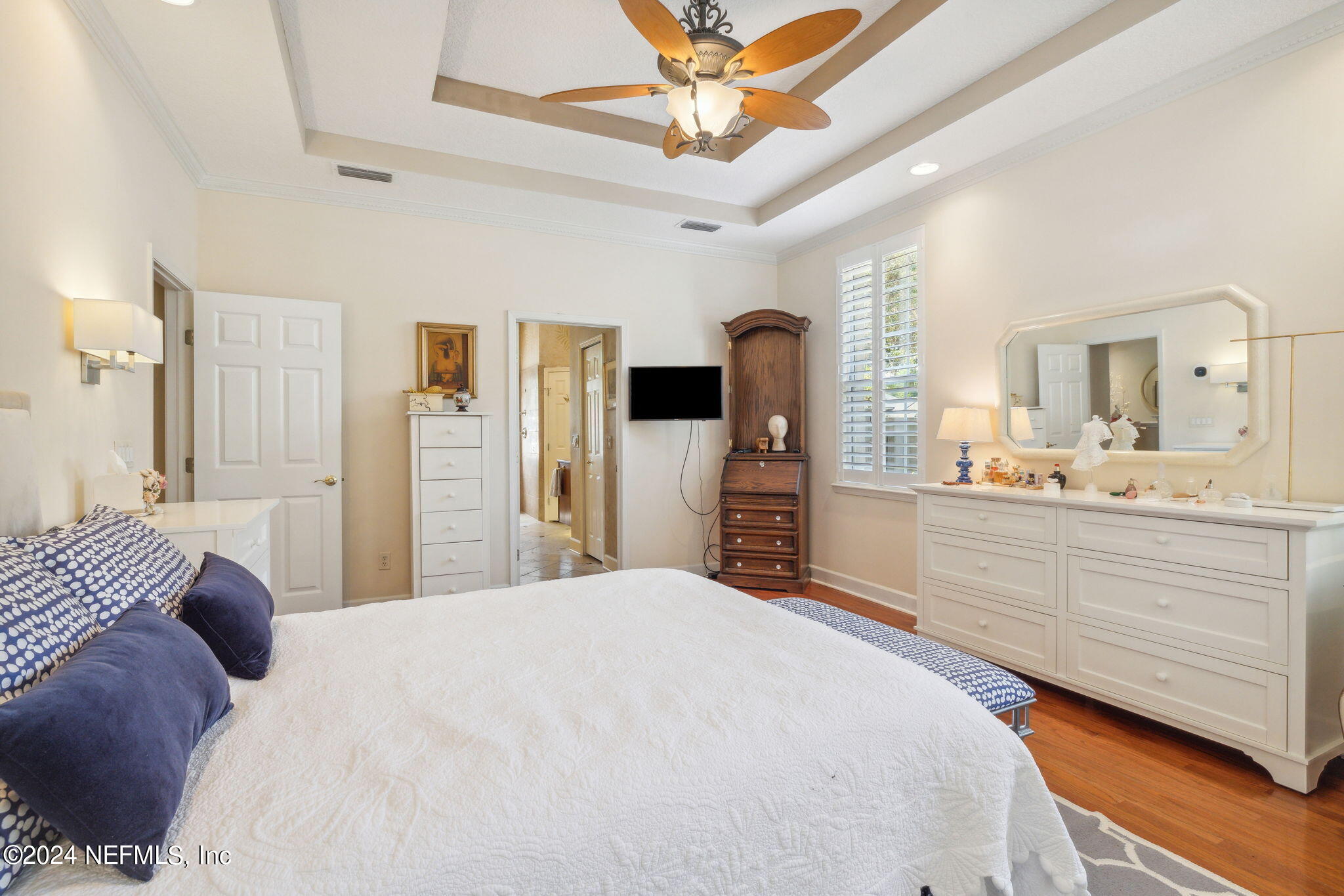144 Bear Pen Road Ponte Vedra Beach, FL 32082 - Photo 32 of 74 a bedroom with a bed a flat screen tv and a chandelier