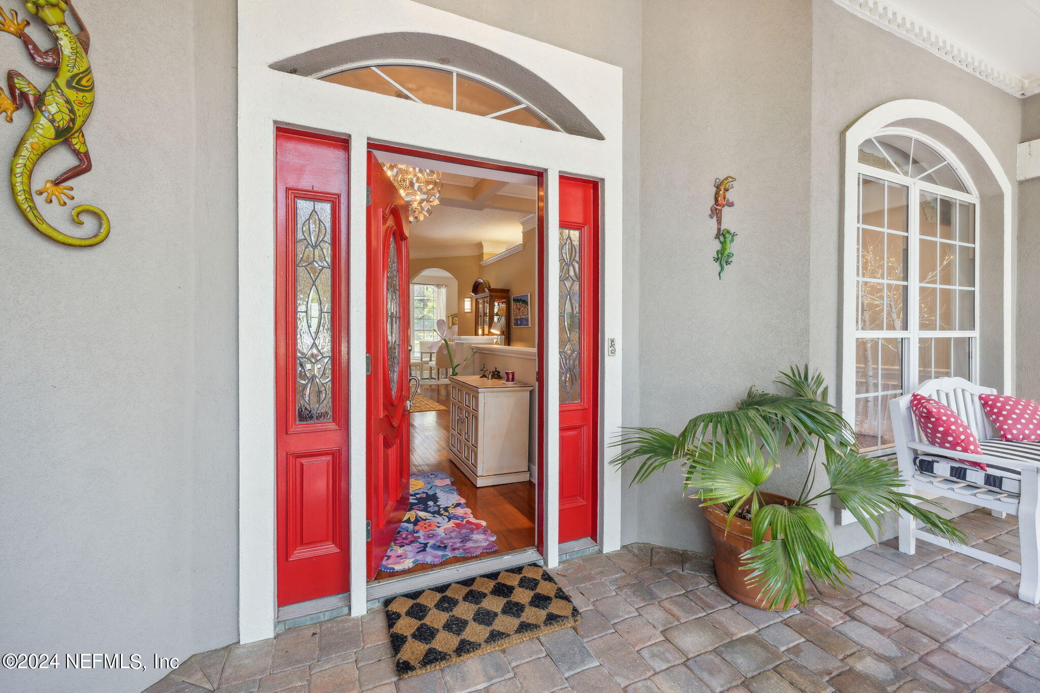 144 Bear Pen Road Ponte Vedra Beach, FL 32082 - Photo 4 of 74 a vase of flowers sitting on a floor in front of a door