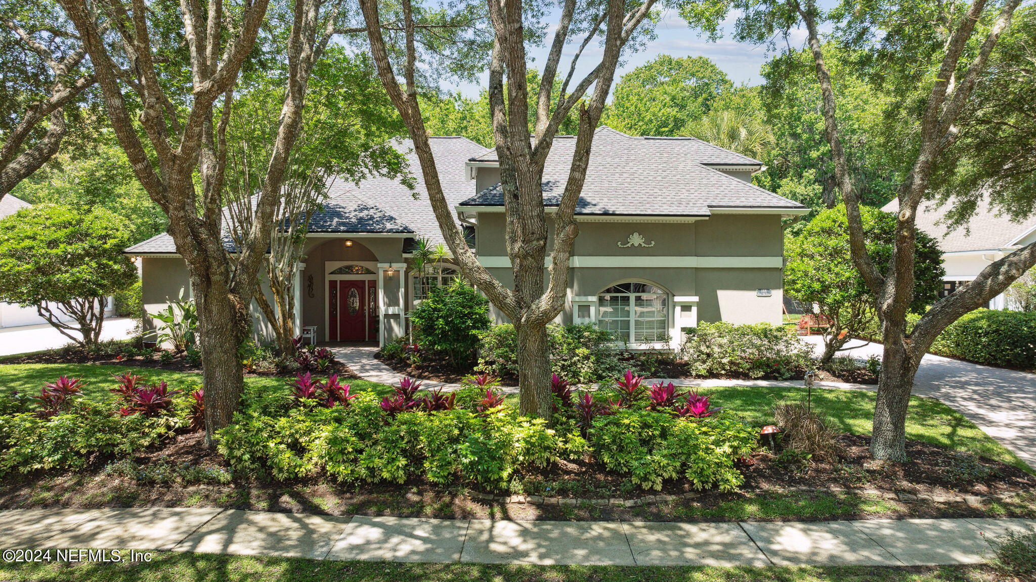 144 Bear Pen Road Ponte Vedra Beach, FL 32082 - Photo 9 of 74 a front view of a house with a yard and fountain in middle