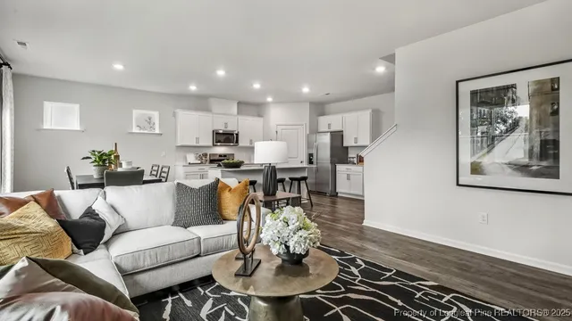 a living room with furniture and kitchen view