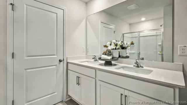 a bathroom with a double vanity sink and a mirror