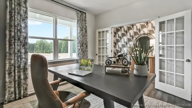 a view of a dining room with furniture and window
