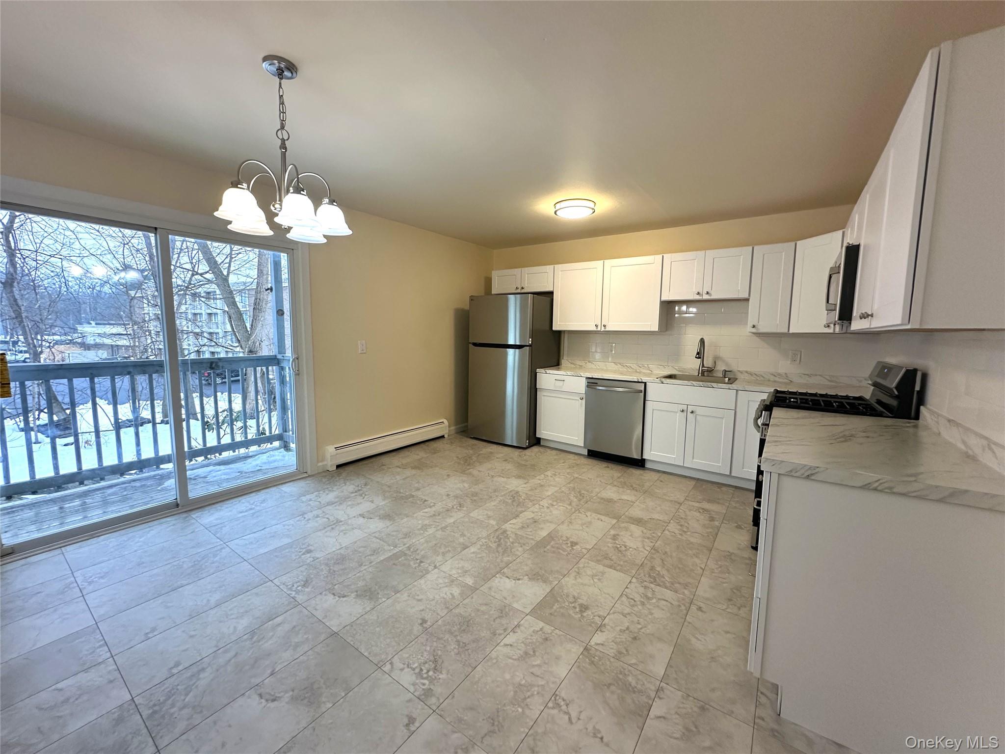 2740 South Road, Unit B7 Poughkeepsie, NY 12601 - Photo 5 of 16 Beautifully renovated Eat in kitchen boast gorgeous Mediterranean look tiles, new counter tops, new white cabinets, all new stainless-steel appliances, new stainless-steel sink and faucet, light fixture and nice access to your very own balcony.