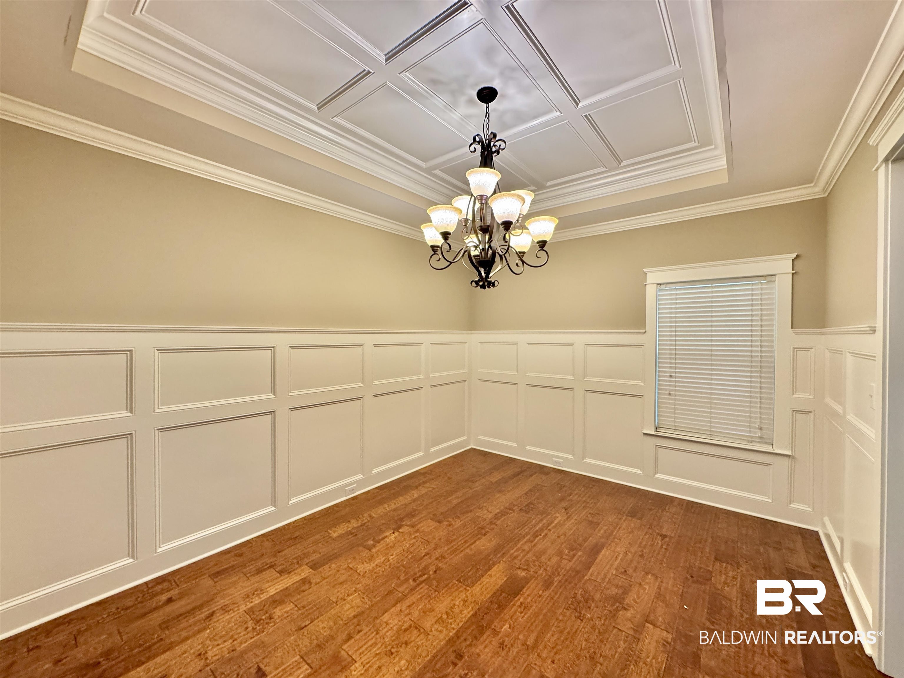 10846 County Road 138 Bay Minette, AL 36507 - Photo 52 of 53 Spare room with a notable chandelier, hardwood / wood-style flooring, and ornamental molding