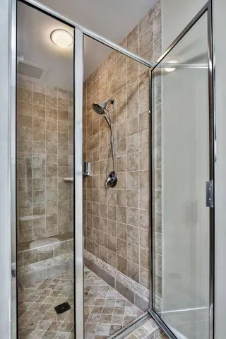 a bathroom with a glass shower door
