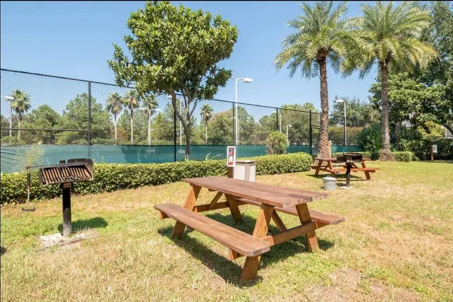 a view of a swimming pool with a patio and a garden