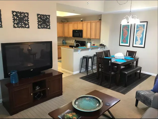 a living room with furniture a dining table and a fireplace