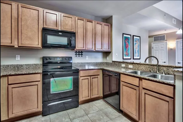 a kitchen with stainless steel appliances granite countertop a stove microwave and sink