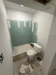 a bathroom with a sink toilet and mirror