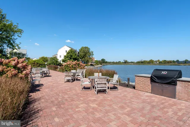 a view of a terrace with furniture and a garden