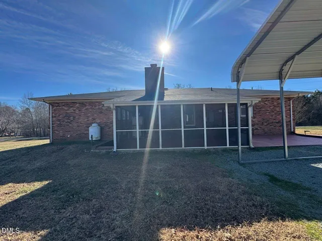 a view of an house with backyard space and balcony