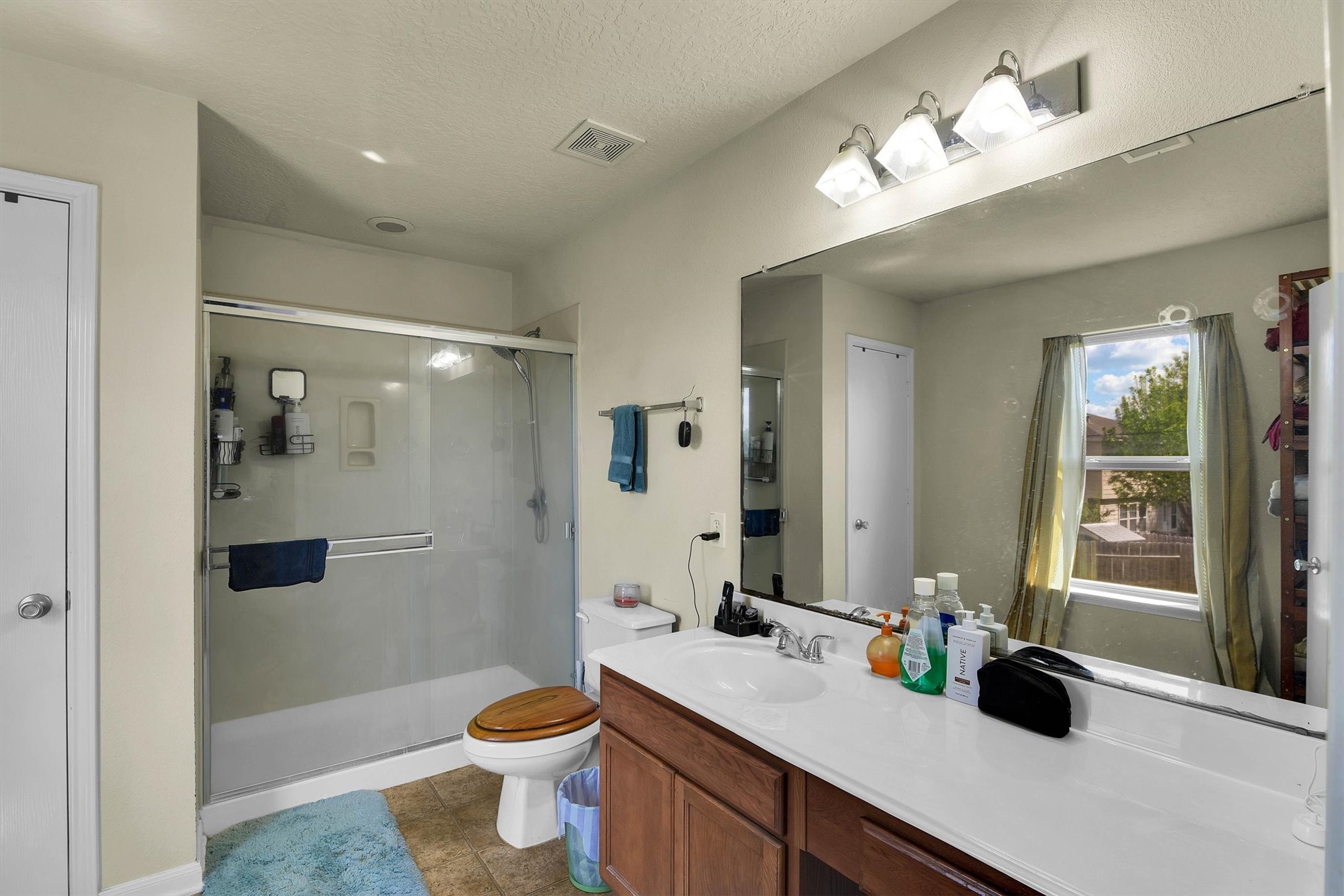 3003 Legends York Drive Spring, TX 77386 - Photo 21 of 29 a bathroom with a double vanity sink toilet and shower