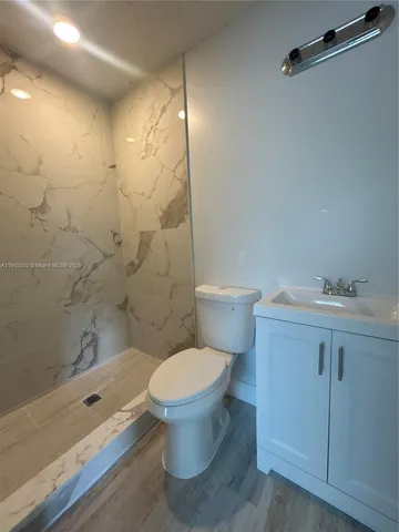 a bathroom with a toilet sink and shower
