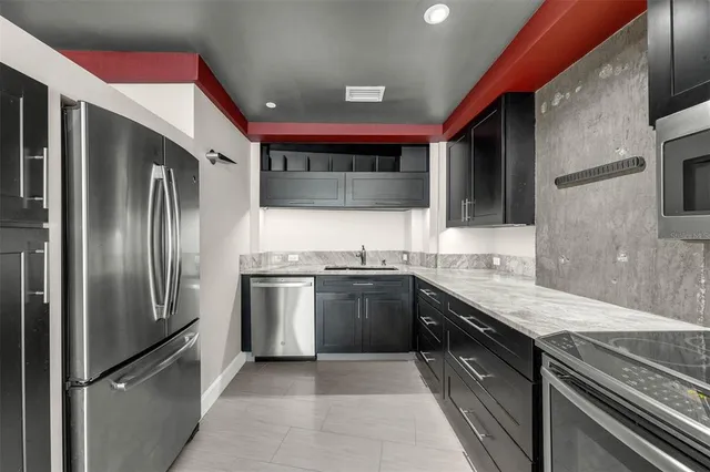 a kitchen with stainless steel appliances granite countertop a sink and cabinets