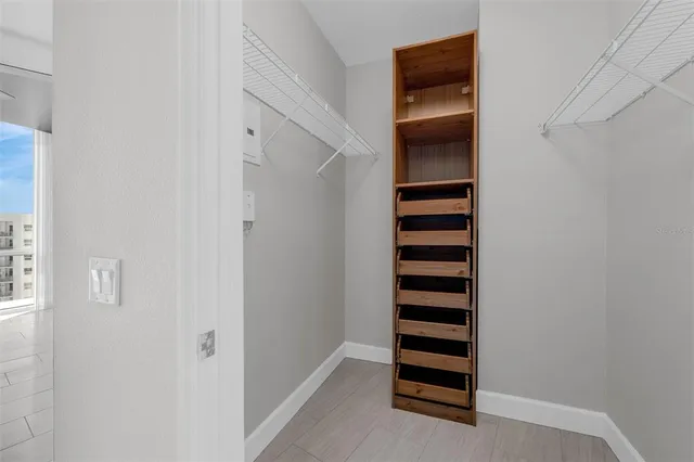 a bathroom with a toilet a sink a mirror and shower