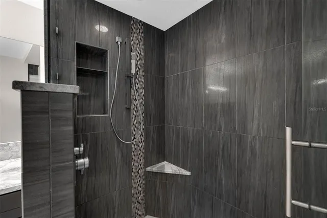 a bathroom with a granite countertop sink a toilet and a mirror