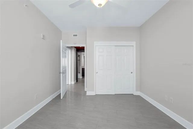 a bathroom with a bathtub shower sink vanity mirror and toilet
