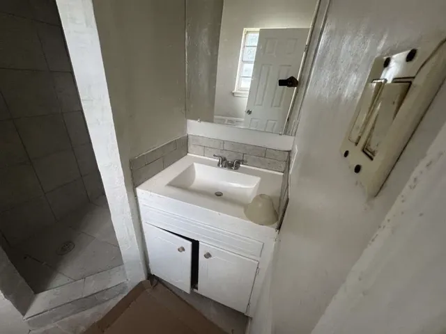 a bathroom with a sink a toilet a mirror and vanity